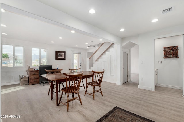 dining area with light wood-style floors, stairway, visible vents, and recessed lighting