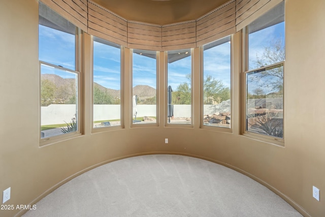 sunroom / solarium featuring a water and mountain view and plenty of natural light