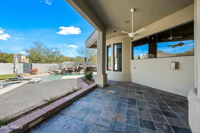 view of patio featuring a fenced in pool and ceiling fan