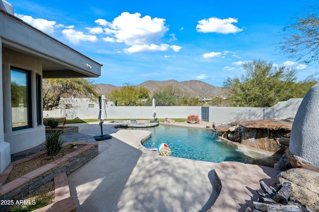 view of swimming pool with a mountain view, a patio area, and pool water feature