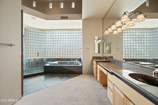 bathroom with vanity, plenty of natural light, and plus walk in shower