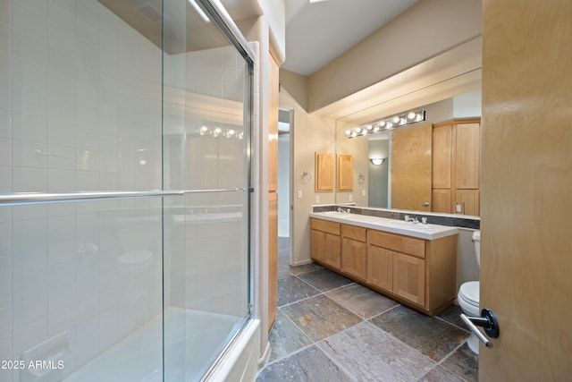 bathroom with vanity and bath / shower combo with glass door