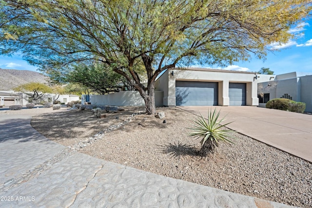 view of front of property with a garage and a mountain view