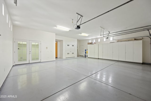 garage with a garage door opener and french doors