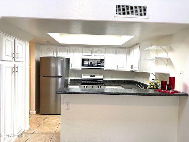 kitchen with white cabinetry, light tile patterned flooring, kitchen peninsula, and stainless steel appliances