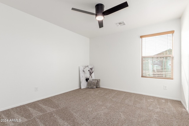 spare room with carpet flooring and ceiling fan