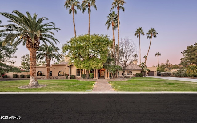 mediterranean / spanish-style home featuring a lawn