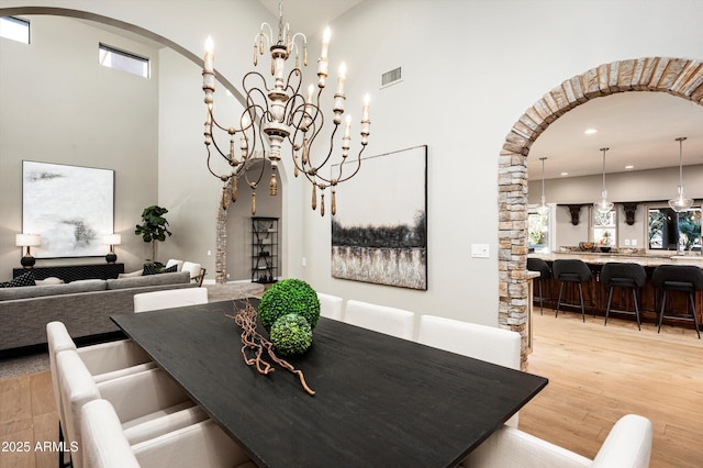 dining area with a notable chandelier and light hardwood / wood-style flooring