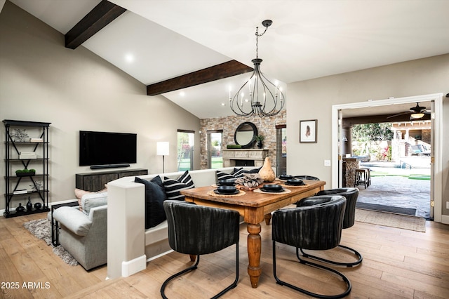 dining area with a healthy amount of sunlight, ceiling fan with notable chandelier, and light hardwood / wood-style flooring