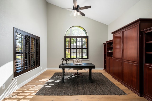 office with ceiling fan, light hardwood / wood-style flooring, and high vaulted ceiling