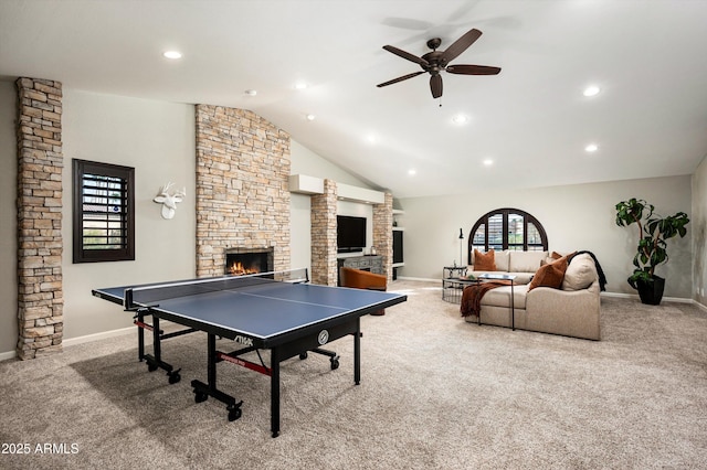 rec room with ceiling fan, light colored carpet, a fireplace, and a wealth of natural light