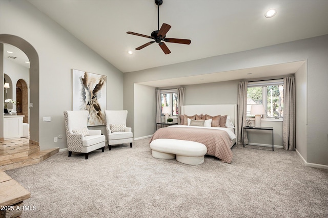 carpeted bedroom with ceiling fan, high vaulted ceiling, and multiple windows