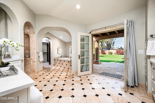 entrance foyer featuring vaulted ceiling and french doors