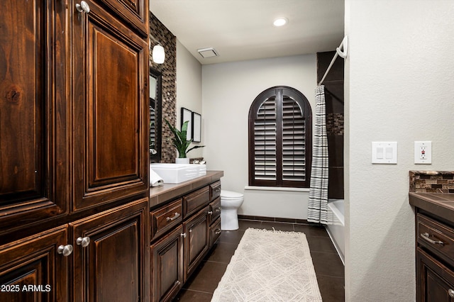 full bathroom with toilet, vanity, shower / bath combo, and tile patterned flooring