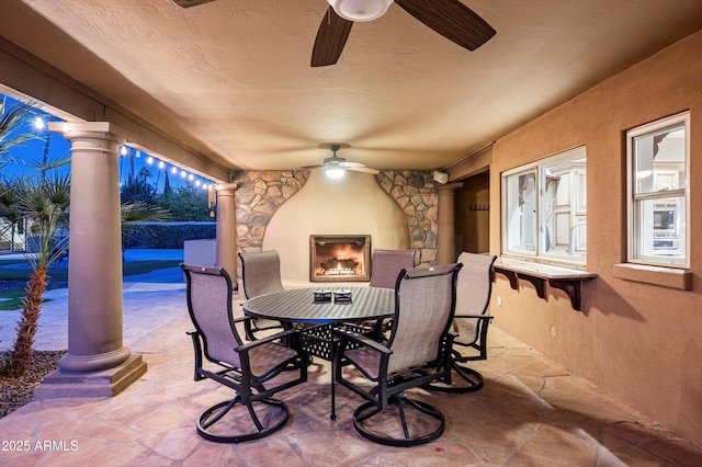 view of patio / terrace featuring an outdoor stone fireplace