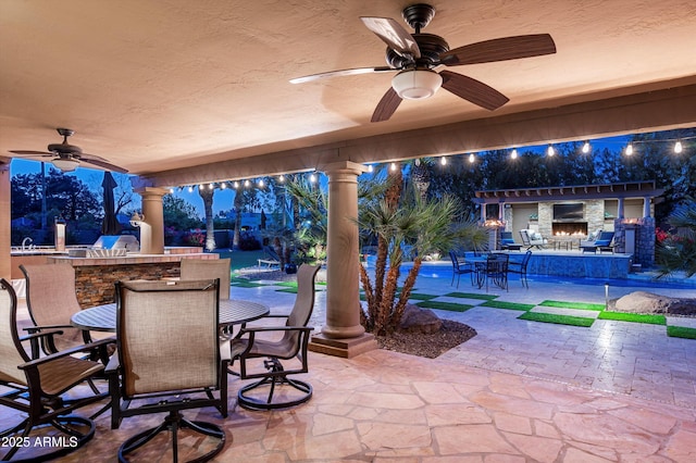 view of patio featuring ceiling fan and exterior bar