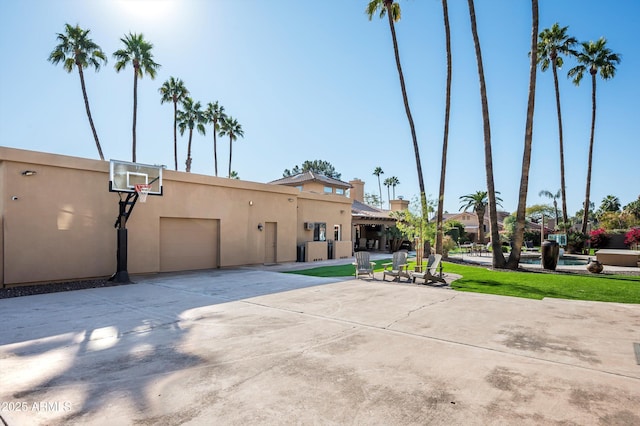 view of basketball court featuring a yard