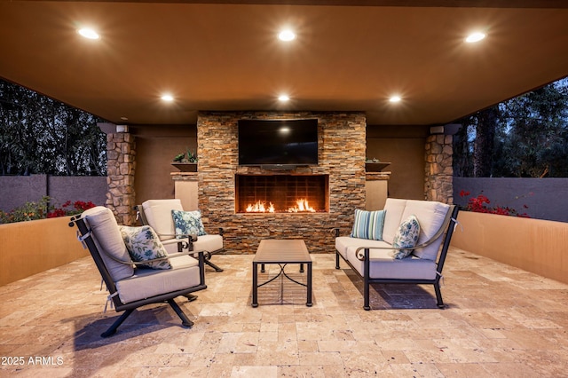 view of patio with an outdoor living space with a fireplace