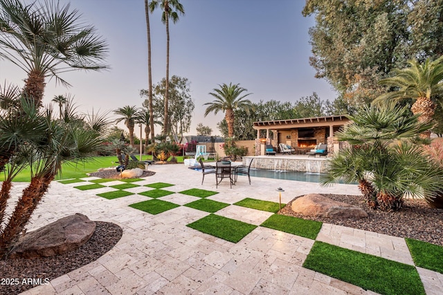 view of property's community with a pool and a patio