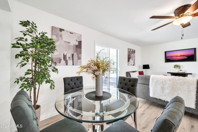 dining space with light wood-type flooring and ceiling fan