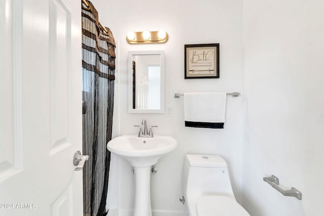 bathroom featuring sink and toilet