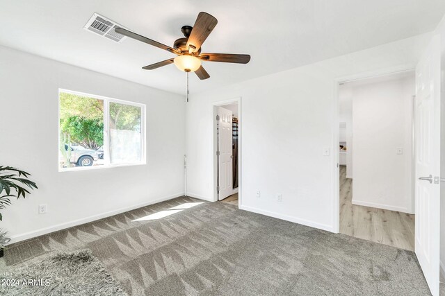 spare room with light hardwood / wood-style floors and ceiling fan