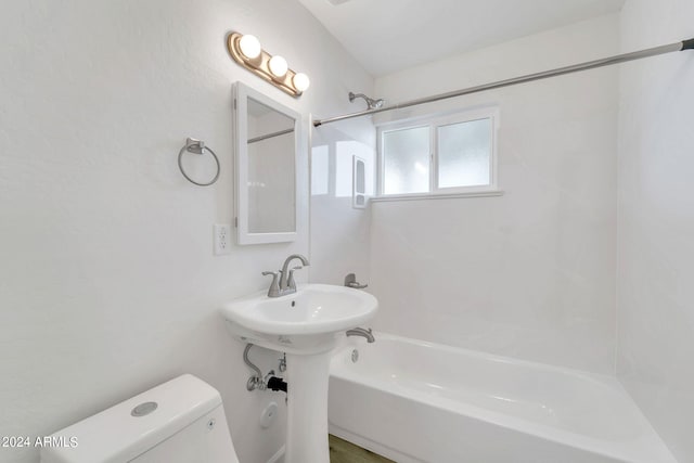 bathroom featuring bathing tub / shower combination, hardwood / wood-style floors, and toilet