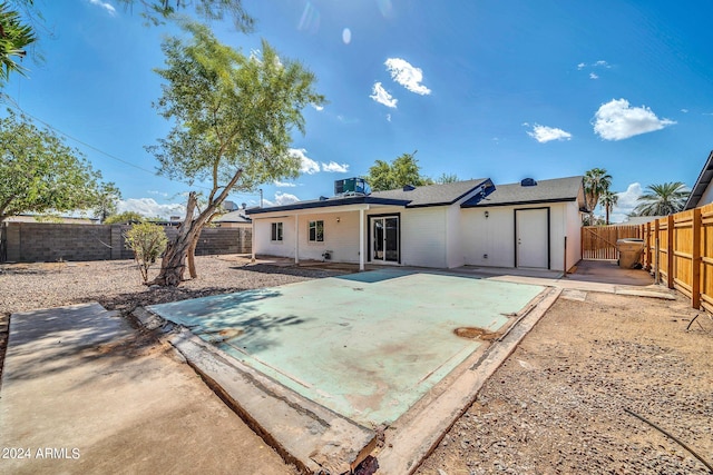 rear view of house featuring cooling unit and a patio area