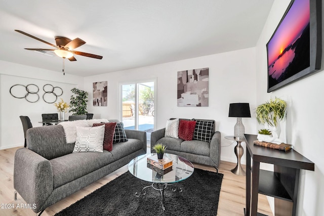 living room with ceiling fan and wood-type flooring