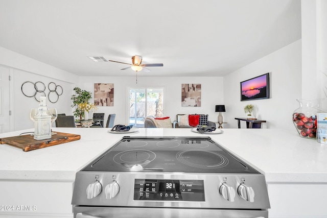 kitchen featuring ceiling fan and stainless steel range