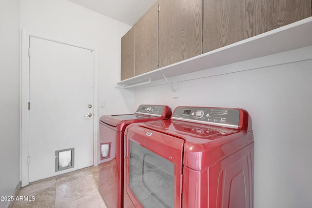 laundry room with separate washer and dryer and cabinets