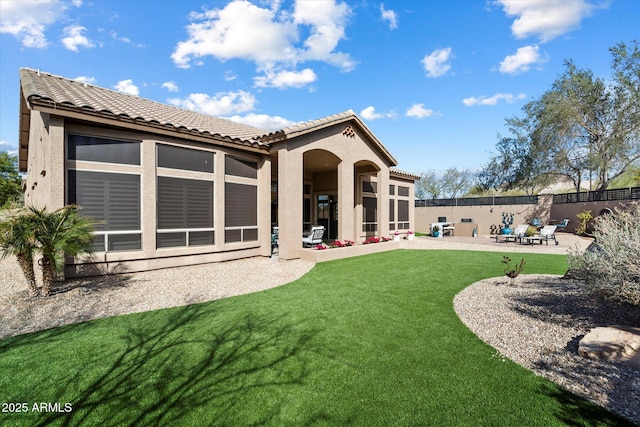 back of house with a patio and a yard