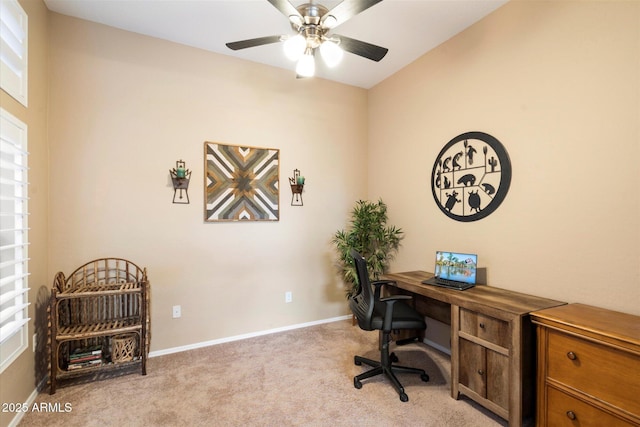 carpeted office space featuring ceiling fan