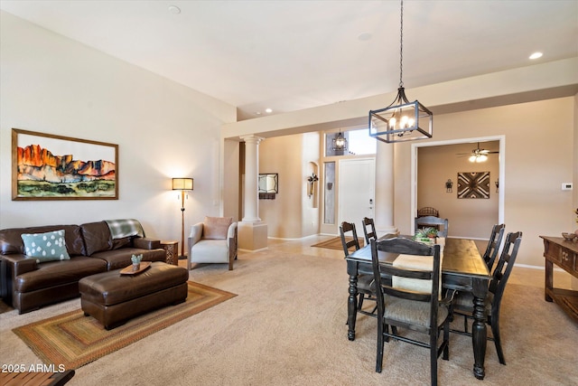 carpeted dining room featuring ornate columns