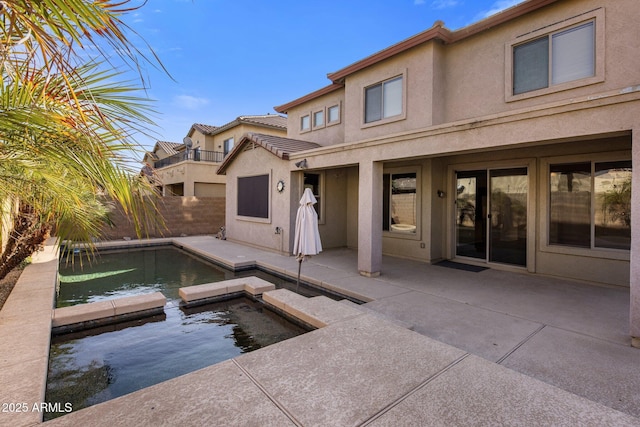 rear view of property with a patio area