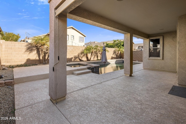 view of patio / terrace with a pool with hot tub