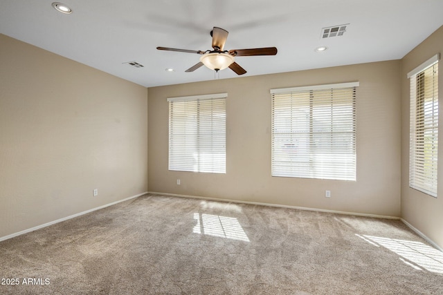 unfurnished room with ceiling fan and light carpet