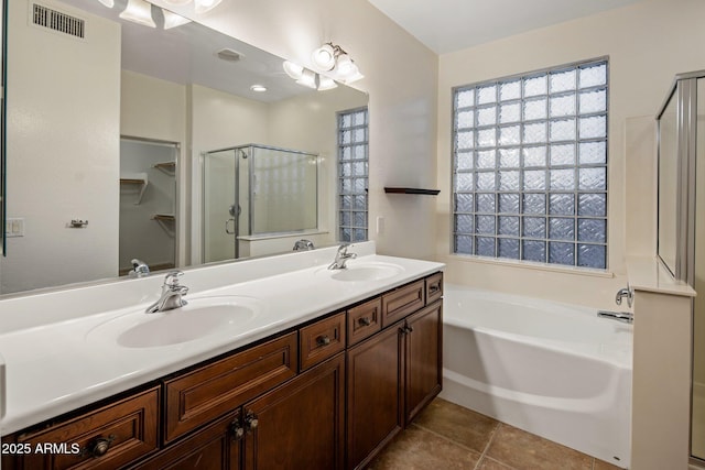 bathroom with vanity, tile patterned floors, and plus walk in shower