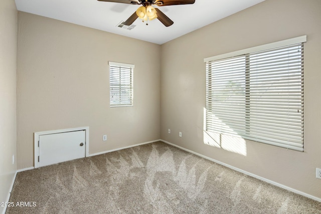 empty room featuring carpet floors and ceiling fan