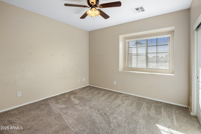 empty room with ceiling fan and carpet