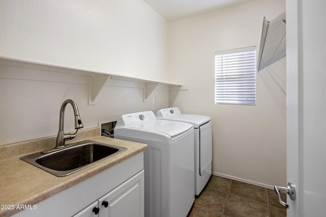 washroom featuring cabinets, sink, dark tile patterned flooring, and independent washer and dryer