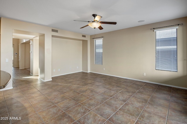 spare room featuring tile patterned floors and ceiling fan