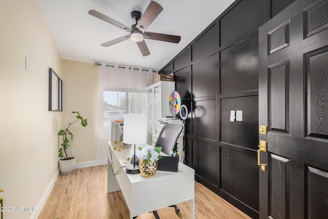 office featuring light wood-type flooring, baseboards, and a ceiling fan