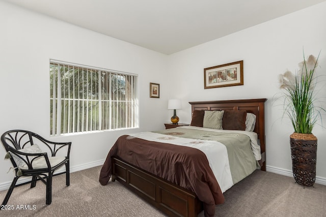 bedroom with baseboards and carpet flooring