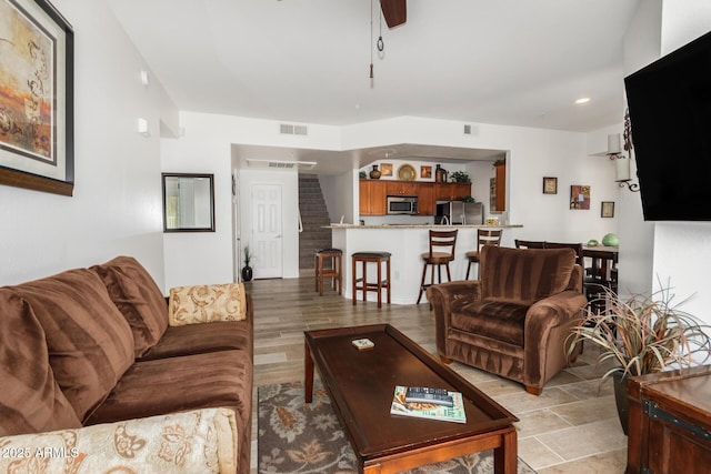 living room with visible vents and ceiling fan