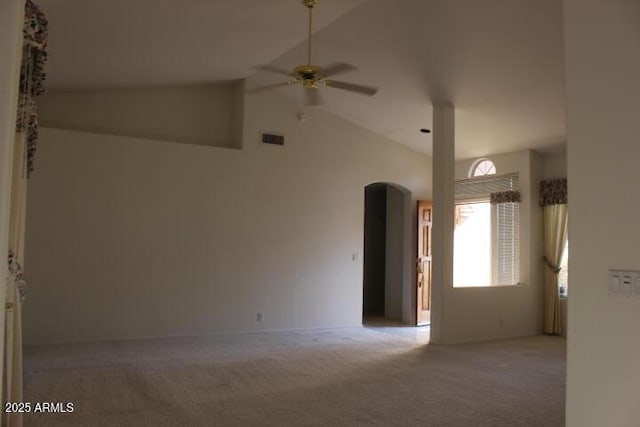 carpeted empty room with ceiling fan and lofted ceiling