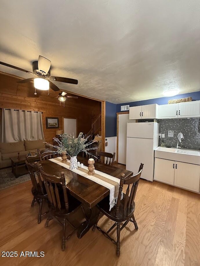 691 N Pyle Ranch Rd, Payson, AZ 85541 - dining space featuring light wood-style flooring, stairs, and ceiling fan