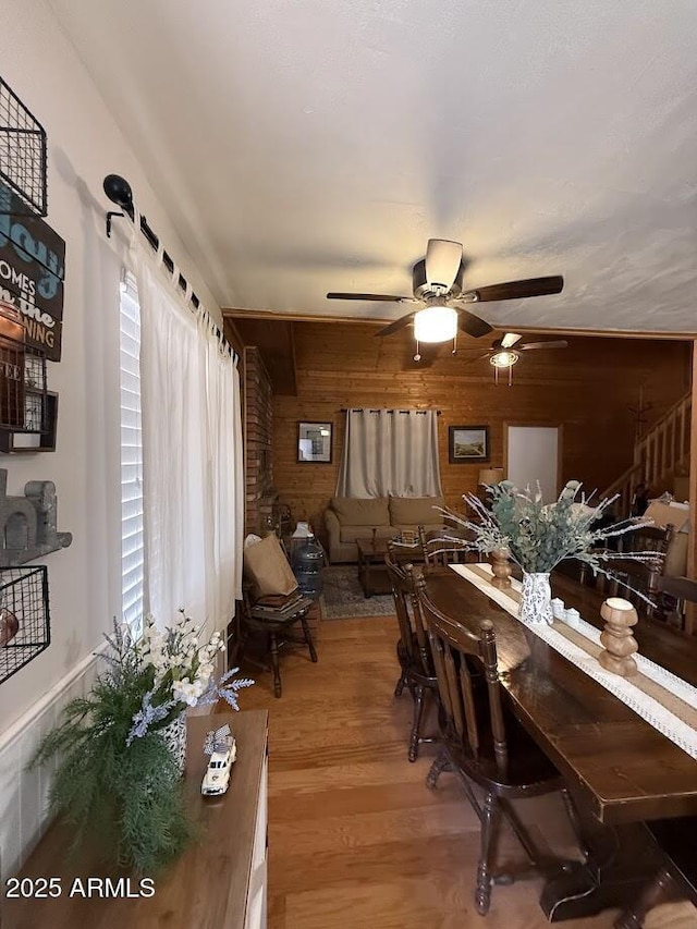 691 N Pyle Ranch Rd, Payson, AZ 85541 - dining area with ceiling fan, light wood-style floors, and wood walls