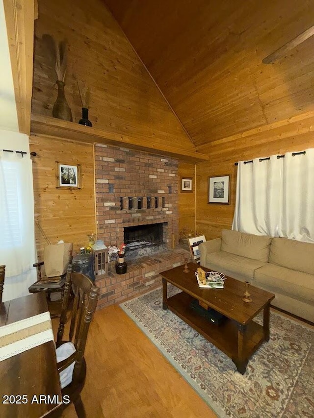 691 N Pyle Ranch Rd, Payson, AZ 85541 - living area featuring wood walls, wood ceiling, high vaulted ceiling, a brick fireplace, and wood finished floors