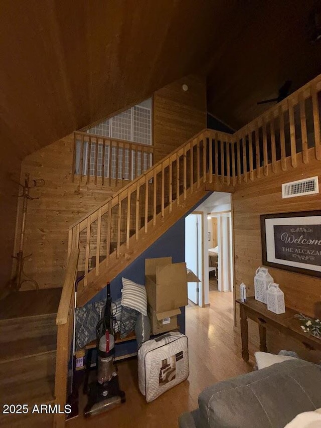 691 N Pyle Ranch Rd, Payson, AZ 85541 - staircase with wooden walls, high vaulted ceiling, and wood finished floors
